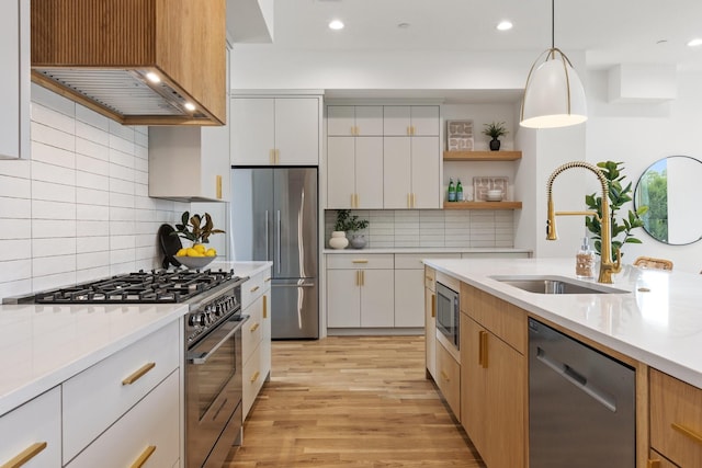 4330 Dickason Ave Unit 201, Dallas, TX 75219 - kitchen featuring premium appliances, a sink, light countertops, light wood-style floors, and recessed lighting