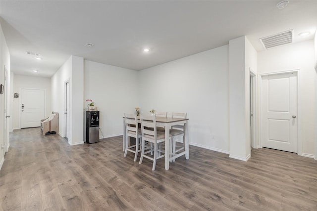 dining space with hardwood / wood-style flooring