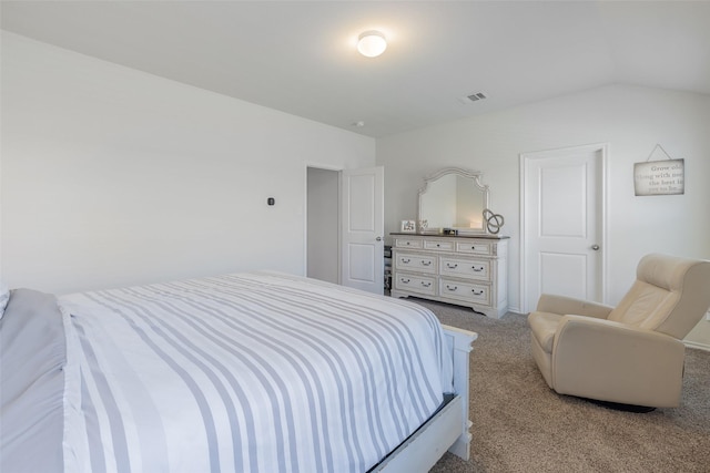 bedroom featuring lofted ceiling and light carpet