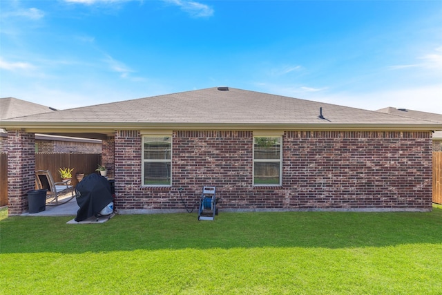 back of house featuring a lawn and a patio area