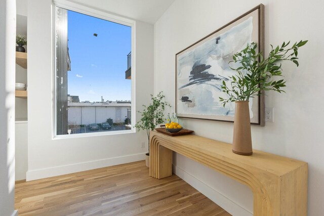 bedroom with hardwood / wood-style flooring, ensuite bath, and access to outside