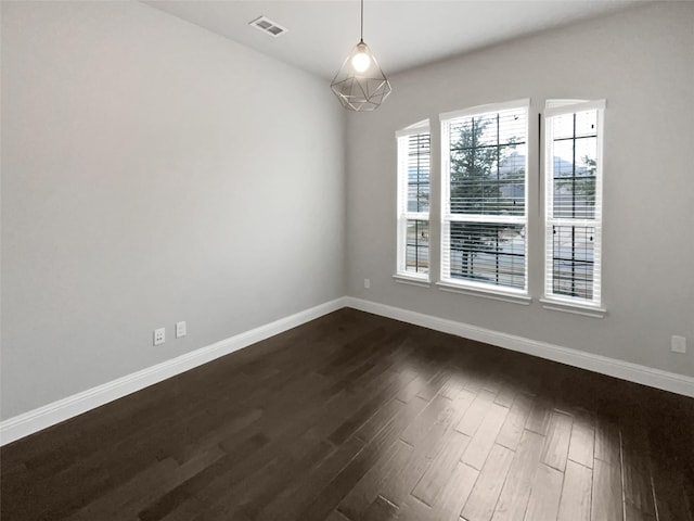 spare room with dark hardwood / wood-style floors