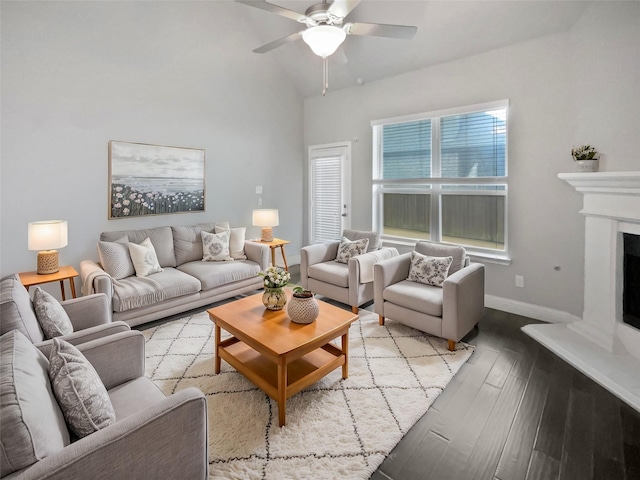 living room featuring ceiling fan, lofted ceiling, and light hardwood / wood-style flooring