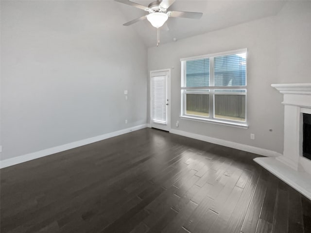 unfurnished living room with vaulted ceiling, dark wood-type flooring, and ceiling fan