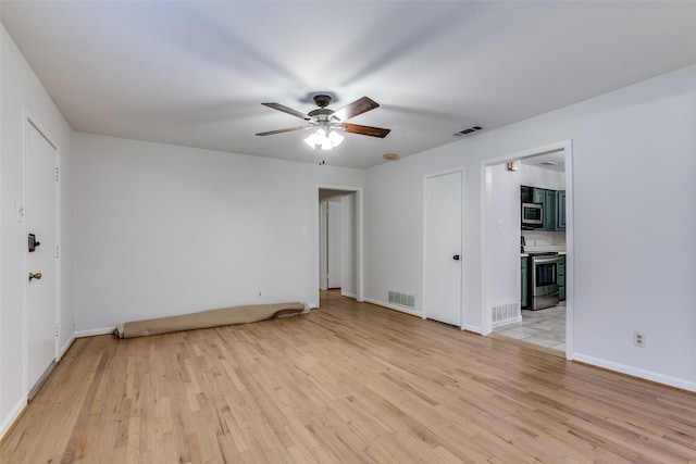 unfurnished room featuring ceiling fan and light wood-type flooring