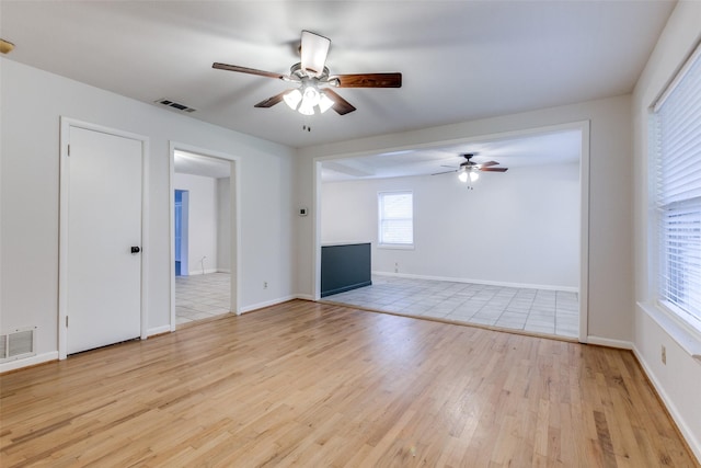 unfurnished living room with ceiling fan and light hardwood / wood-style floors