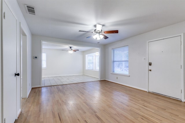 foyer entrance featuring plenty of natural light, ceiling fan, and light wood-type flooring