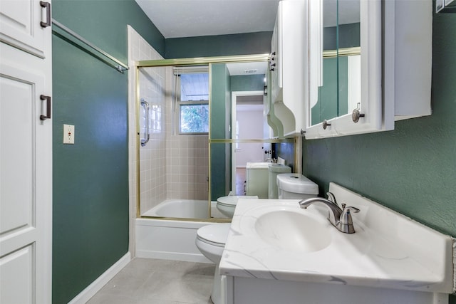 full bathroom with vanity, bath / shower combo with glass door, tile patterned floors, and toilet