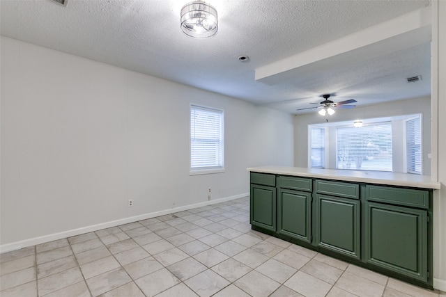 unfurnished room featuring a textured ceiling and ceiling fan