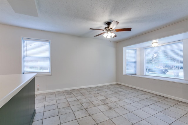 unfurnished room with a textured ceiling and ceiling fan