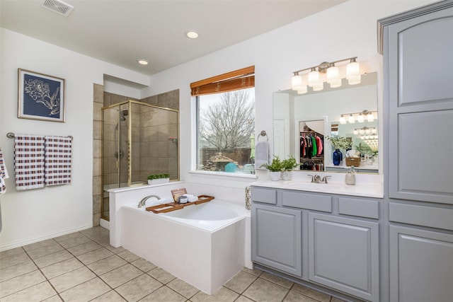 bathroom featuring vanity, tile patterned floors, and plus walk in shower