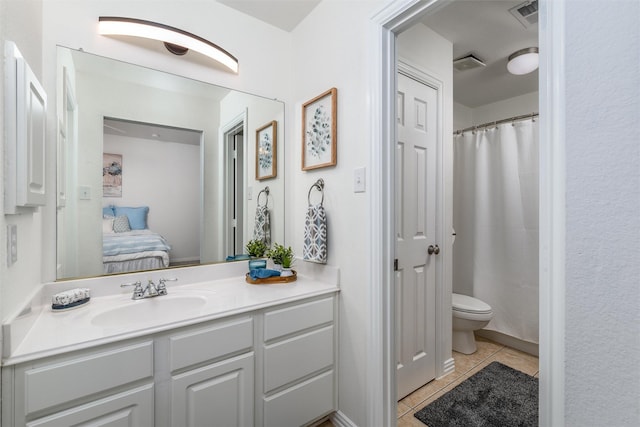 bathroom featuring tile patterned floors, toilet, and vanity