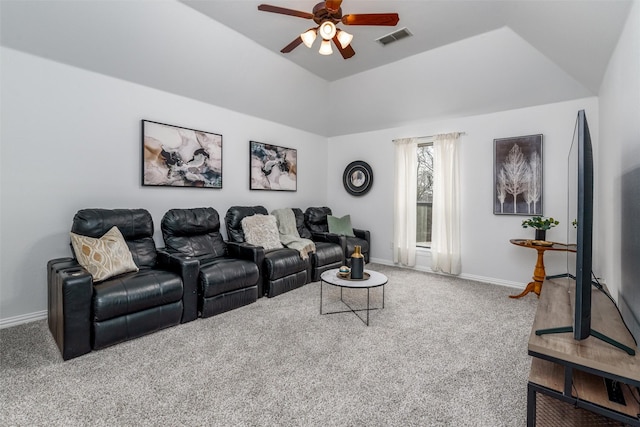 carpeted cinema with ceiling fan and vaulted ceiling