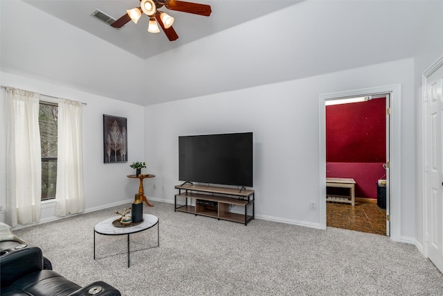 carpeted living room featuring vaulted ceiling and ceiling fan