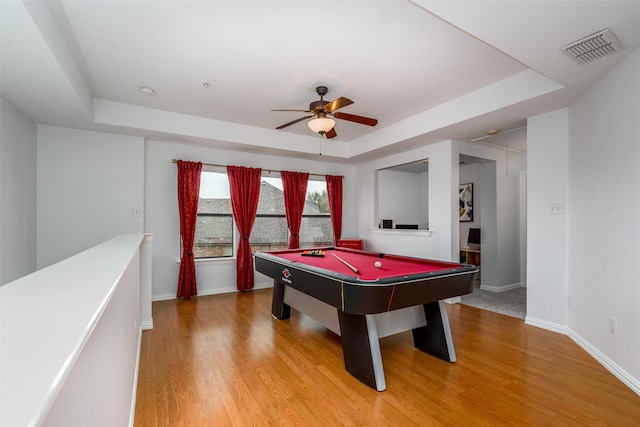 game room featuring a tray ceiling, wood-type flooring, and pool table