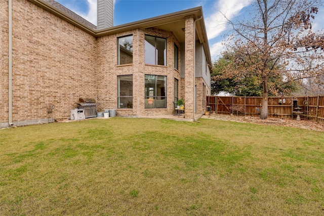 rear view of property featuring a lawn