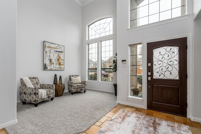 carpeted entryway featuring a high ceiling