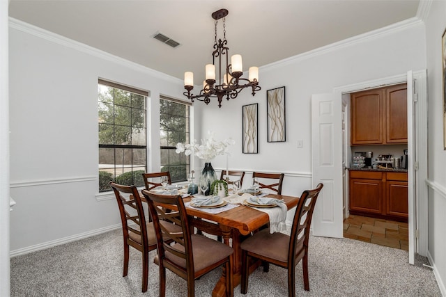 carpeted dining space with ornamental molding and a notable chandelier