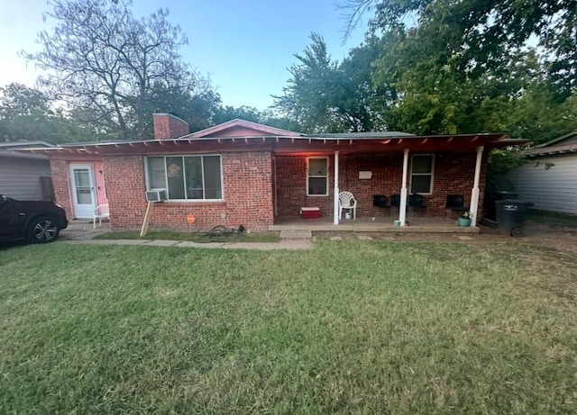 back of property with a patio, cooling unit, and a lawn