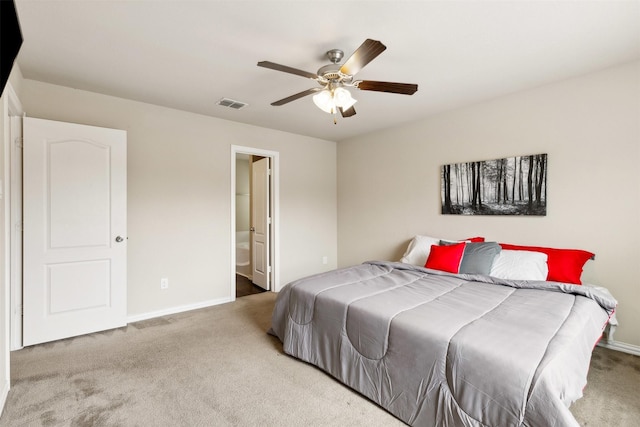 bedroom with connected bathroom, ceiling fan, and carpet