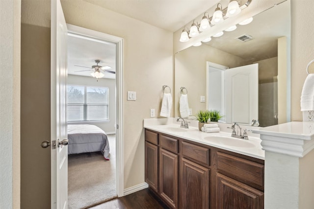 bathroom featuring hardwood / wood-style flooring, ceiling fan, and vanity