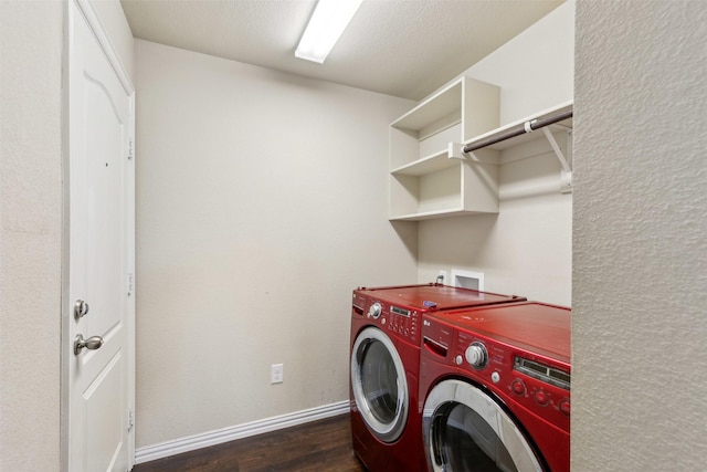 clothes washing area featuring dark wood-type flooring, separate washer and dryer, and a textured ceiling