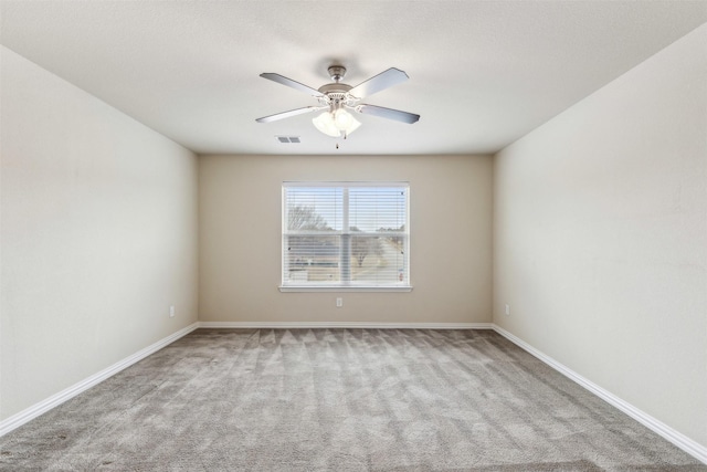 carpeted spare room featuring ceiling fan