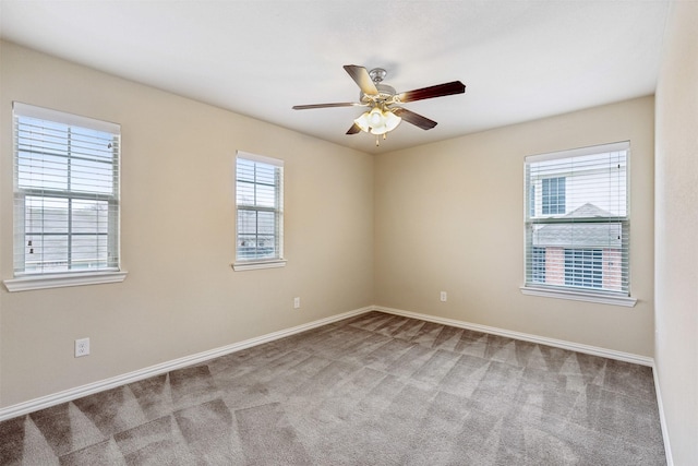 spare room featuring carpet floors and ceiling fan