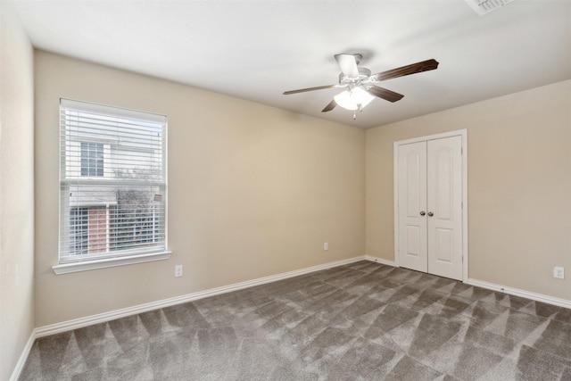 unfurnished bedroom with carpet floors, a closet, and ceiling fan