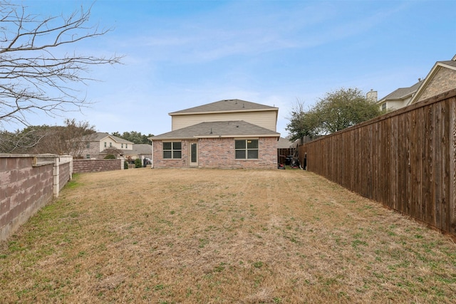 back of property with a lawn