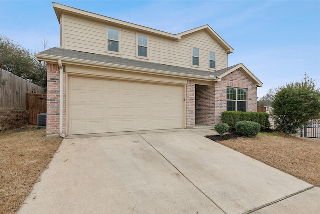 view of front of property with a garage and central AC