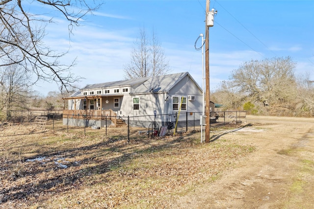 rear view of property with covered porch