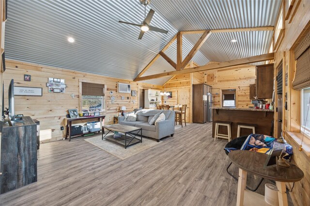 bedroom featuring wood ceiling, wooden walls, ensuite bath, and wood-type flooring