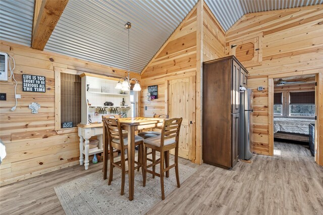 bedroom with wood ceiling, light hardwood / wood-style floors, an AC wall unit, and wood walls