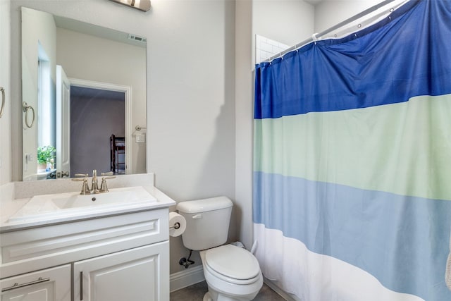 bathroom featuring walk in shower, vanity, and toilet