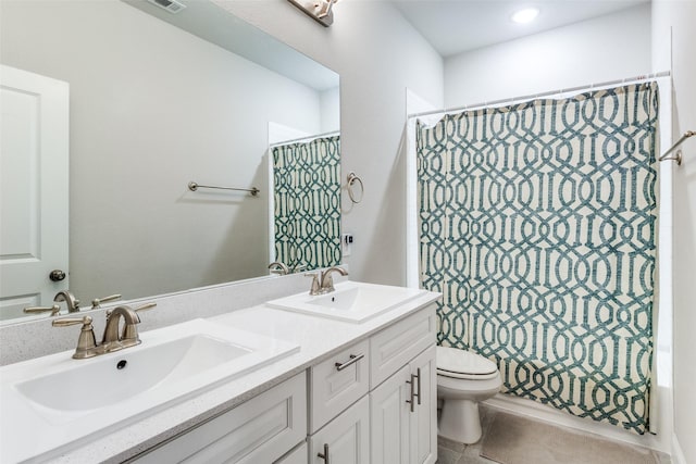 full bathroom featuring tile patterned floors, vanity, toilet, and shower / bath combo with shower curtain