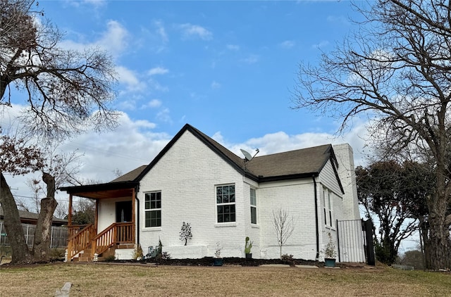 rear view of house with a yard