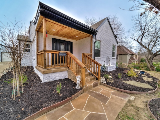 view of side of home with covered porch