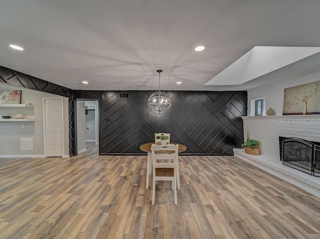 interior space with hardwood / wood-style floors, a notable chandelier, and a fireplace