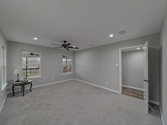 carpeted spare room with ceiling fan