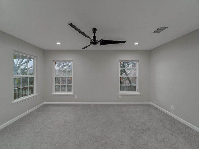 carpeted spare room with ceiling fan