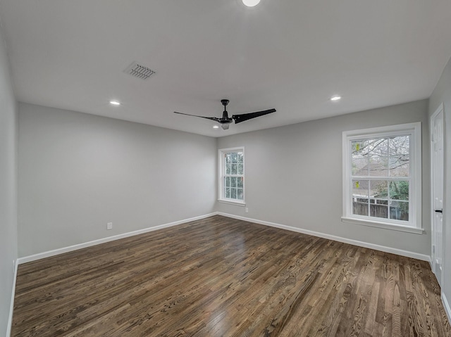 unfurnished room with dark wood-type flooring and ceiling fan