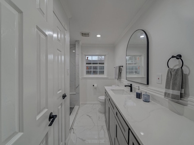 bathroom featuring vanity, crown molding, toilet, and tiled shower