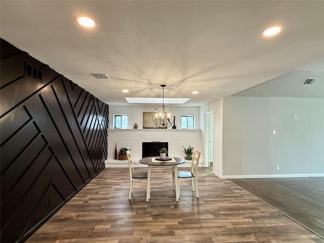 dining area with an inviting chandelier and wood-type flooring