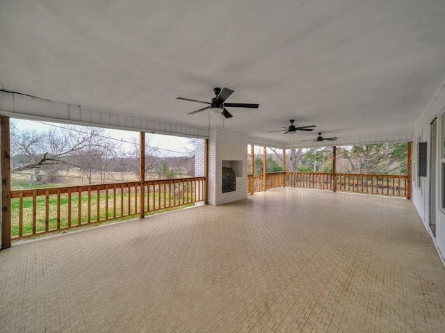 exterior space featuring a fireplace and ceiling fan