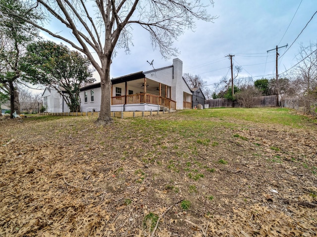 view of yard with a wooden deck and ceiling fan