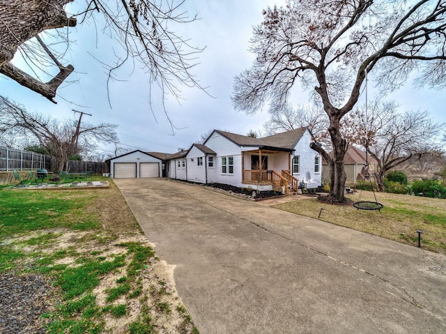 single story home featuring a garage, an outdoor structure, and a front lawn