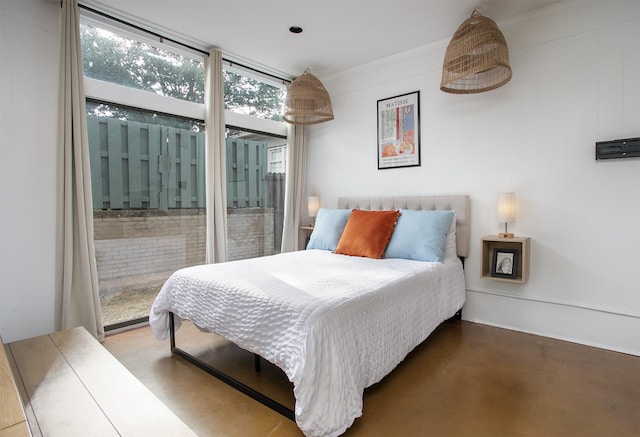 bedroom featuring floor to ceiling windows and concrete flooring