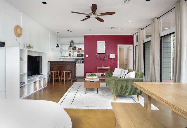 living room with dark hardwood / wood-style flooring and ceiling fan