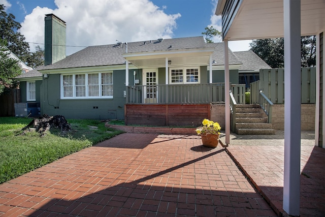 back of property with a patio